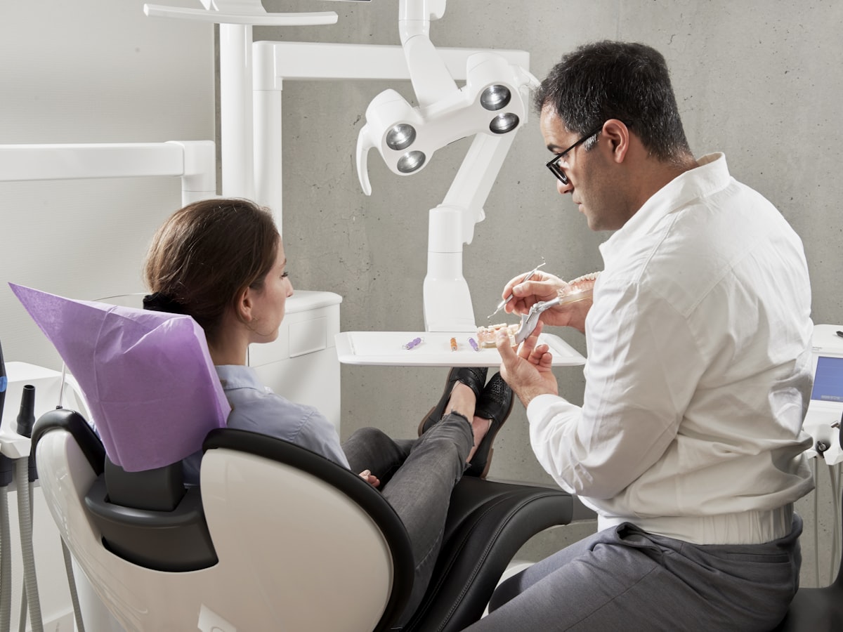 Dentist explaining treatment to a patient at Genesis Dental Centre